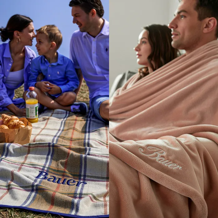 zu sehen ist ein zweigeteiltes Bild; links eine Familie beim Picknick, die Picknick Decke mit Logo steht im Vordergrund; auf der anderen Seite ein Paar eingekuschelt in eine beige Winterdecke, die ebenfalls mit einem Logo bestickt ist