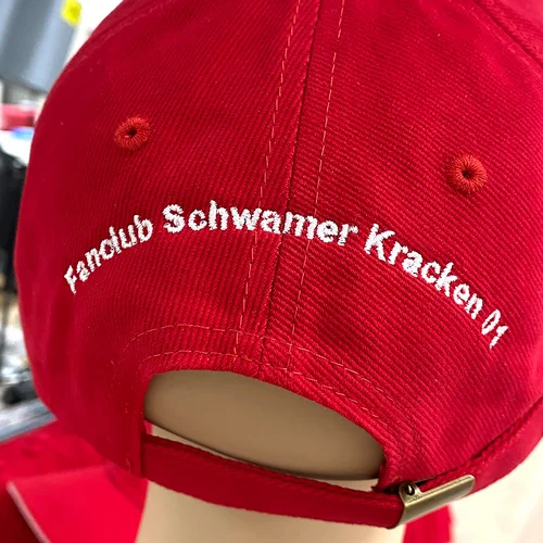 Eine rote Cap für Sport mit der Stickerei "Fanclub Schwamer Kracken 01"